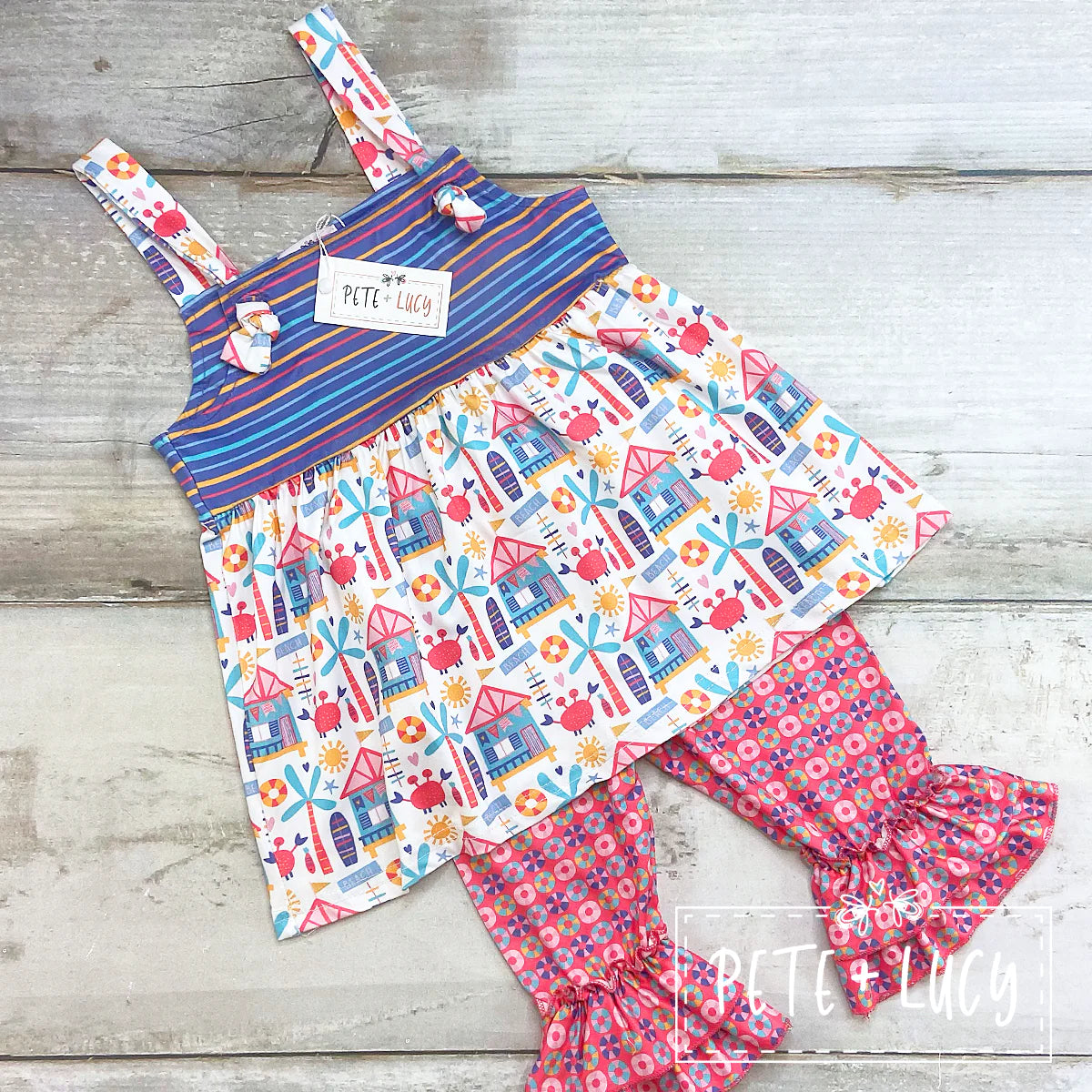 Head into summer in style with this irresistibly adorable and comfy Beach Days 2-piece Capri Set! This cutie features an adjustable strap top, with a great mix of print fabrics, and a flouncy ruffle hem on the pants leg--it's the perfect look for a day of fun in the sun!