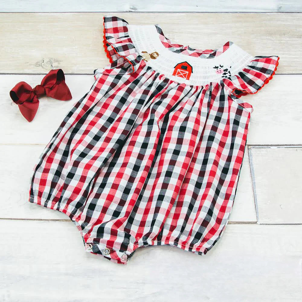 Look like the happiest little farmer in town wearing this "Welcome to the farm girl's bubble romper"! With a classic, red white and navy blue print, plus bric-a-brac trimmed flutter sleeve and farm-life embroidered smocking around the neck, it's as cute as a basketful of kittens! So get ready: hayrides await!