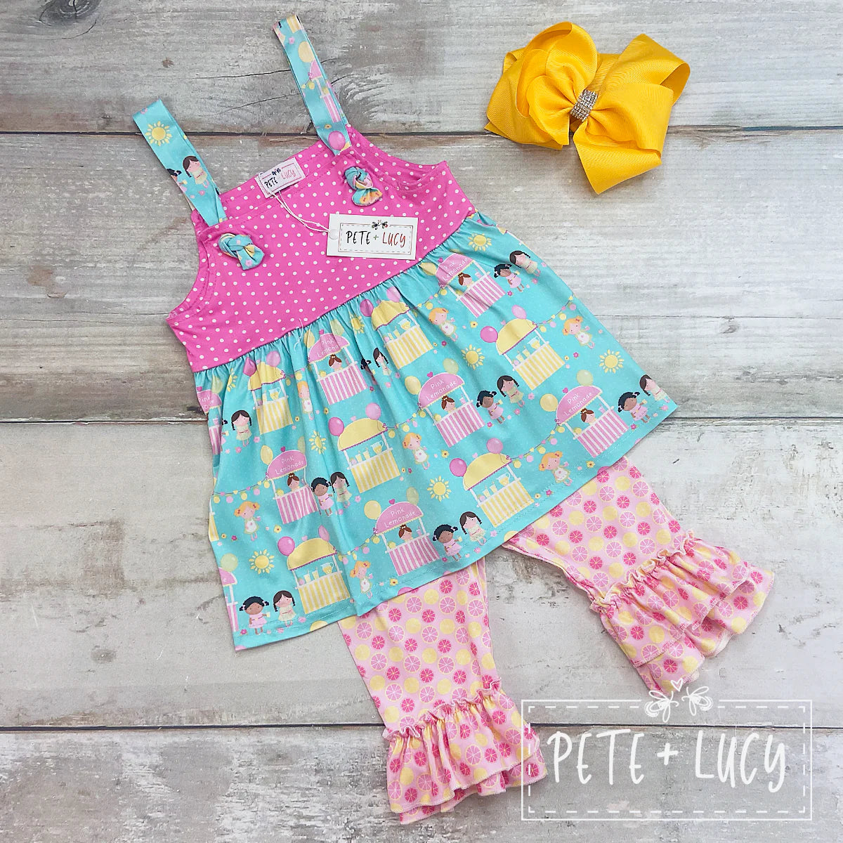This Pink Lemonade 2-piece Capri set is sure to give your little one the sour-sweet feeling of summer all year round! Perfect for days at the playground or a party, the adjustable top straps and the double ruffle hem are sure to make a fashion statement. Mix up your designs with this adorable summer set! Don't forget to check out our sibling sets.