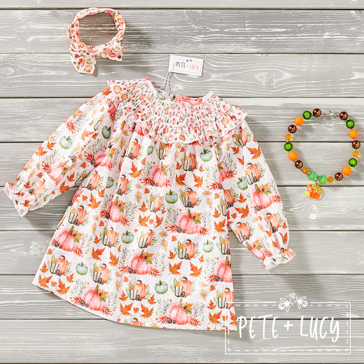 This darling long sleeve Pumpkin print dress is a Fall must-have for your little ones! The smocked detailing is simply stunning - perfect for a fabulous fall pic! Your kiddo will be the talk of the town in this chic pumpkin print dress - and they'll stay fashionable and comfy all season long! Smocking is the perfect way to add a bit of fun to a timeless print.