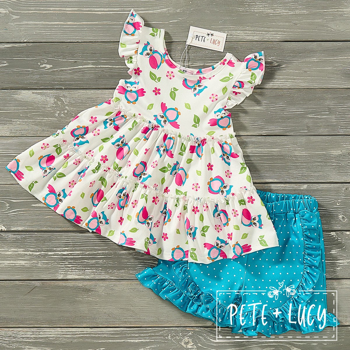 "Be the cutest owl in town with this 2-piece short set! Featuring a charming floral and owl print top with flounce sleeves, paired with teal polka dot ruffle shorts. Double the ruffles, double the fun!"