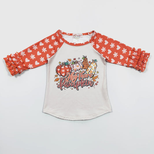 Welcome the season of pumpkin spice and everything nice with this raglan shirt! Super cute and comfy, featuring a ruffled print sleeve and a playful "Hey-There-Pumpkin" graphic. Fall in love with this one - get it quick before it's gone!