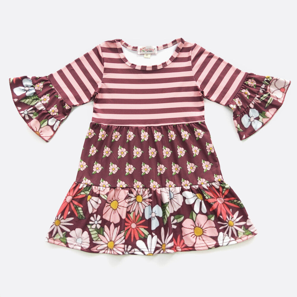 Loving this Garnet Blooms multi-fabric dress! With its adorable 3/4 double ruffle sleeves and luxuriously soft milk silk fabric, you'll look fierce and feel comfy - nothing like having your cake and eating it too! The use of the floral and stripe fabric is on point! They'll have you standing out like a queen bee. Go ahead and flaunt it!