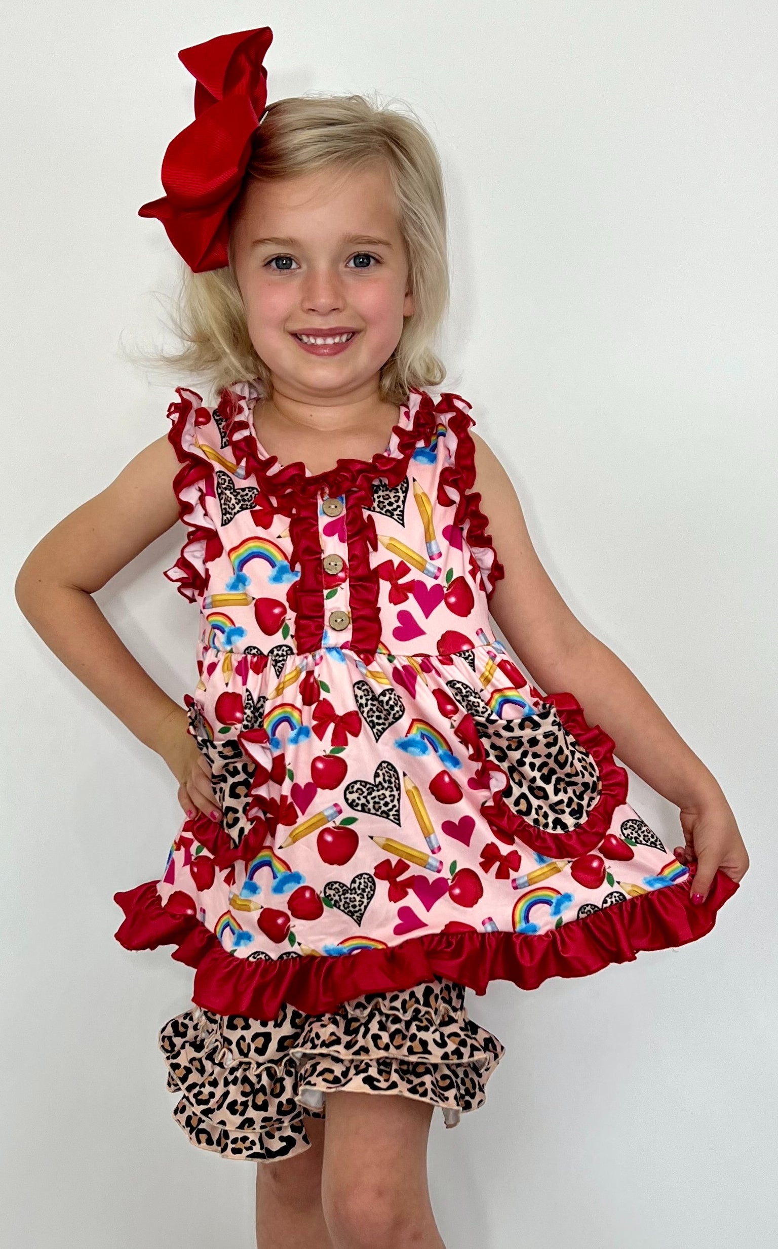 This Love and Leopard 2 Piece Ruffled Short Set is an adorable boutique outfit for your little one. The heart, rainbow and apple print top features leopard print pockets, while the leopard print shorts have double ruffles for a stylish look. 🌈💖