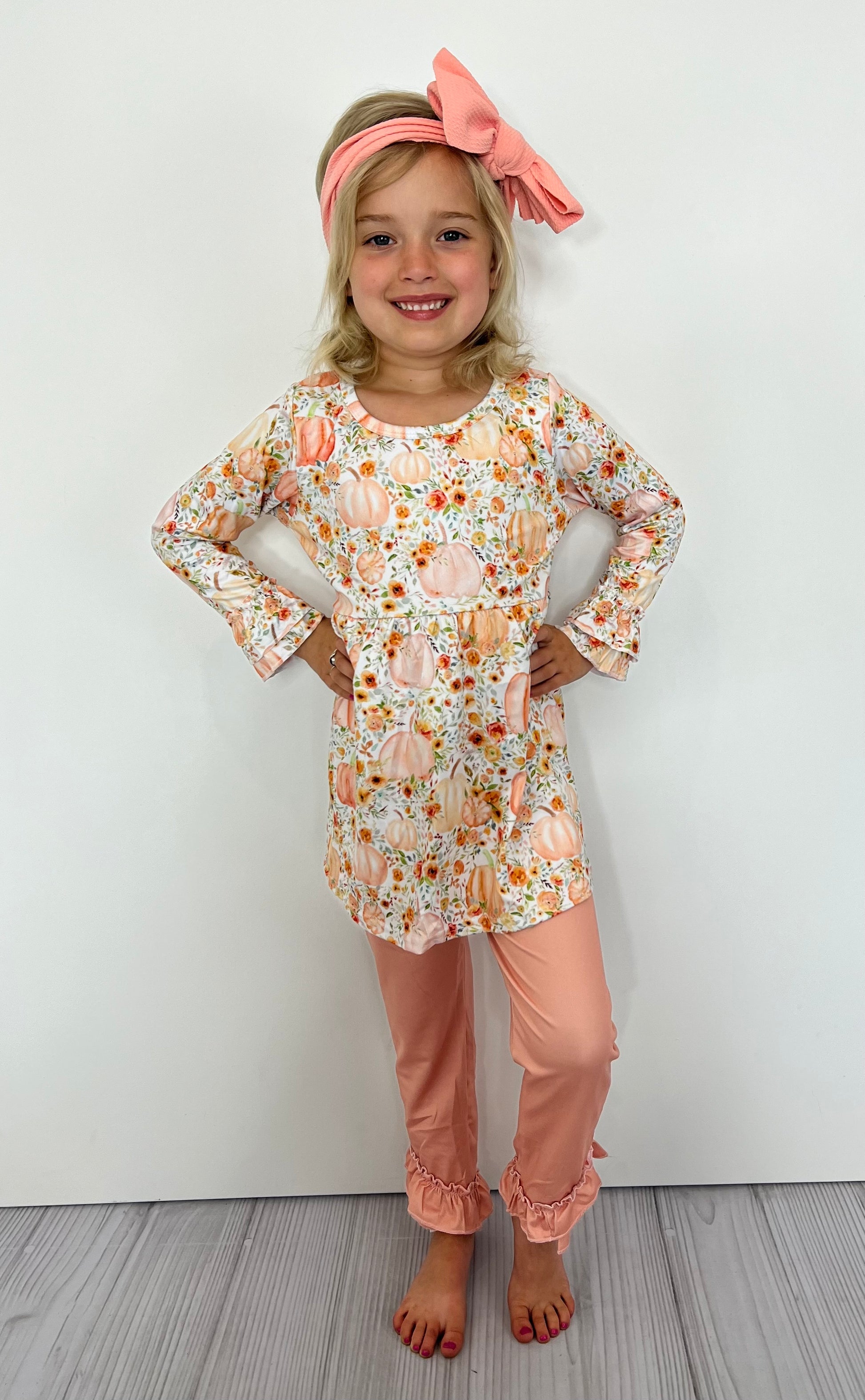 This delightful 2-piece set has all the fun and whimsy of fall! The beautiful pumpkin pattern on the long sleeve shirt will have your little one feeling extra pretty, while the peach colored pant with double ruffle hem will add a playful touch. Love the joy of autumn with this special set!