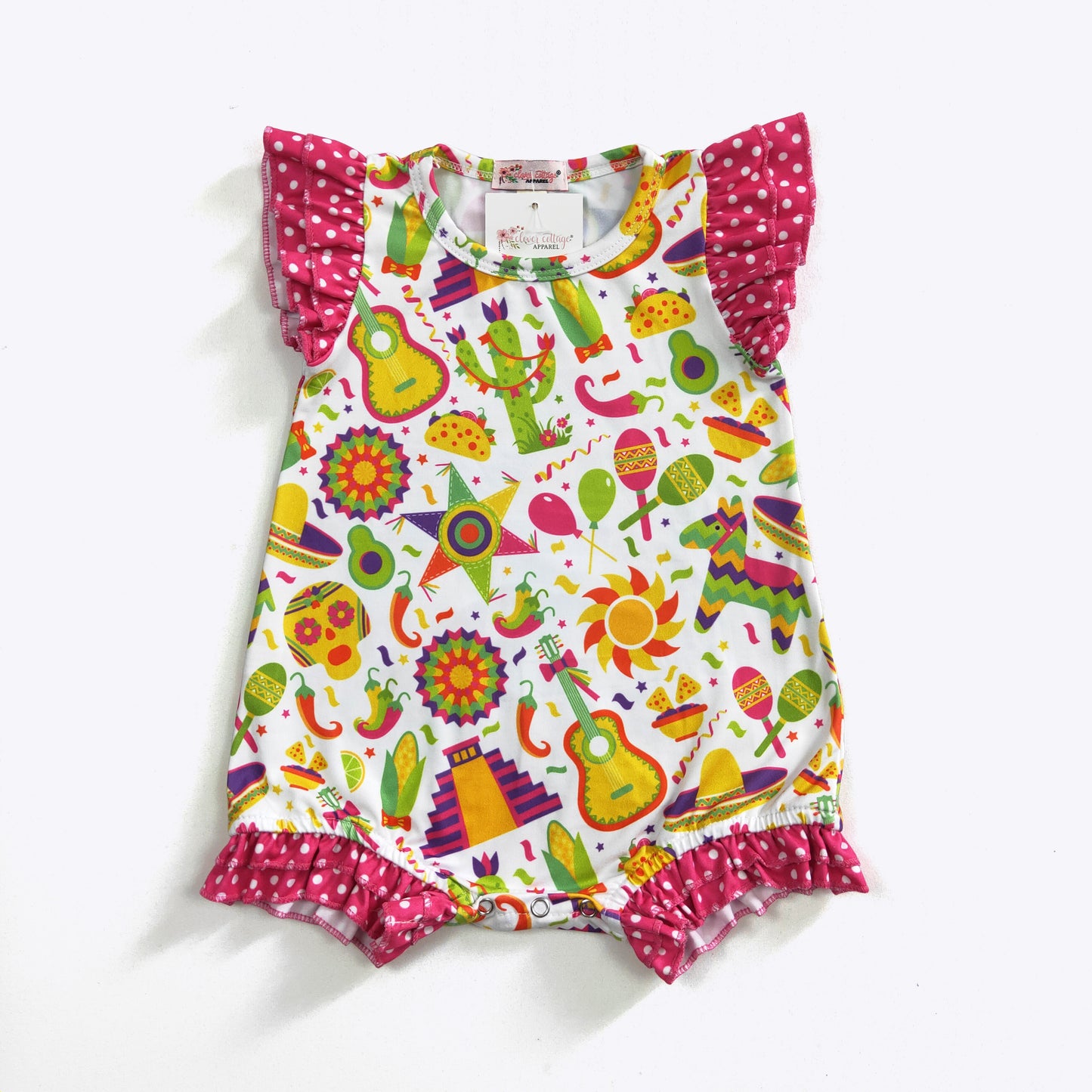 Get ready to fiesta with this playful and vibrant infant girl's shorty romper! Featuring a fun fiesta print and hot pink polka dot fabrics, this romper will have your little one looking adorable. With flutter ruffle sleeves and legs, and a convenient snap crotch, this romper is perfect for any fiesta-loving baby.