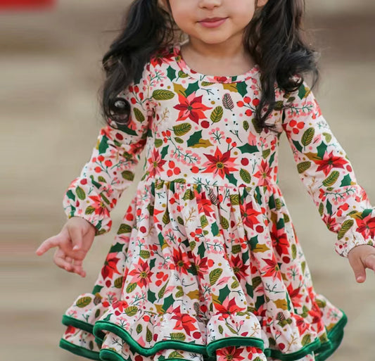 This Perfect Poinsettia Double Ruffle Dress is just what you need to spice up your holiday photos. Its beautiful poinsettia print and double ruffle hem with green piping make it a festive stunner! Get ready to wow with this long-sleeve dress, complete with elastic at the wrists for a perfect fit.