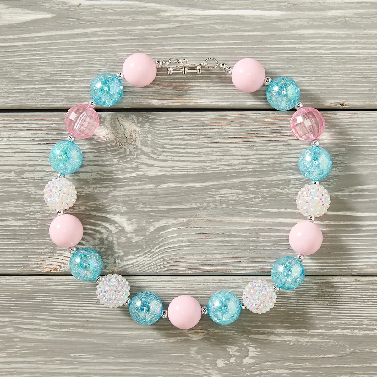Complete the look with one of our Bubble Gum Necklaces — a chunky 18" of fun your kid won't be able to resist! With a clasp for easy closure and beads that look good enough to eat (but don't!), it's the perfect accessory for any kiddo!