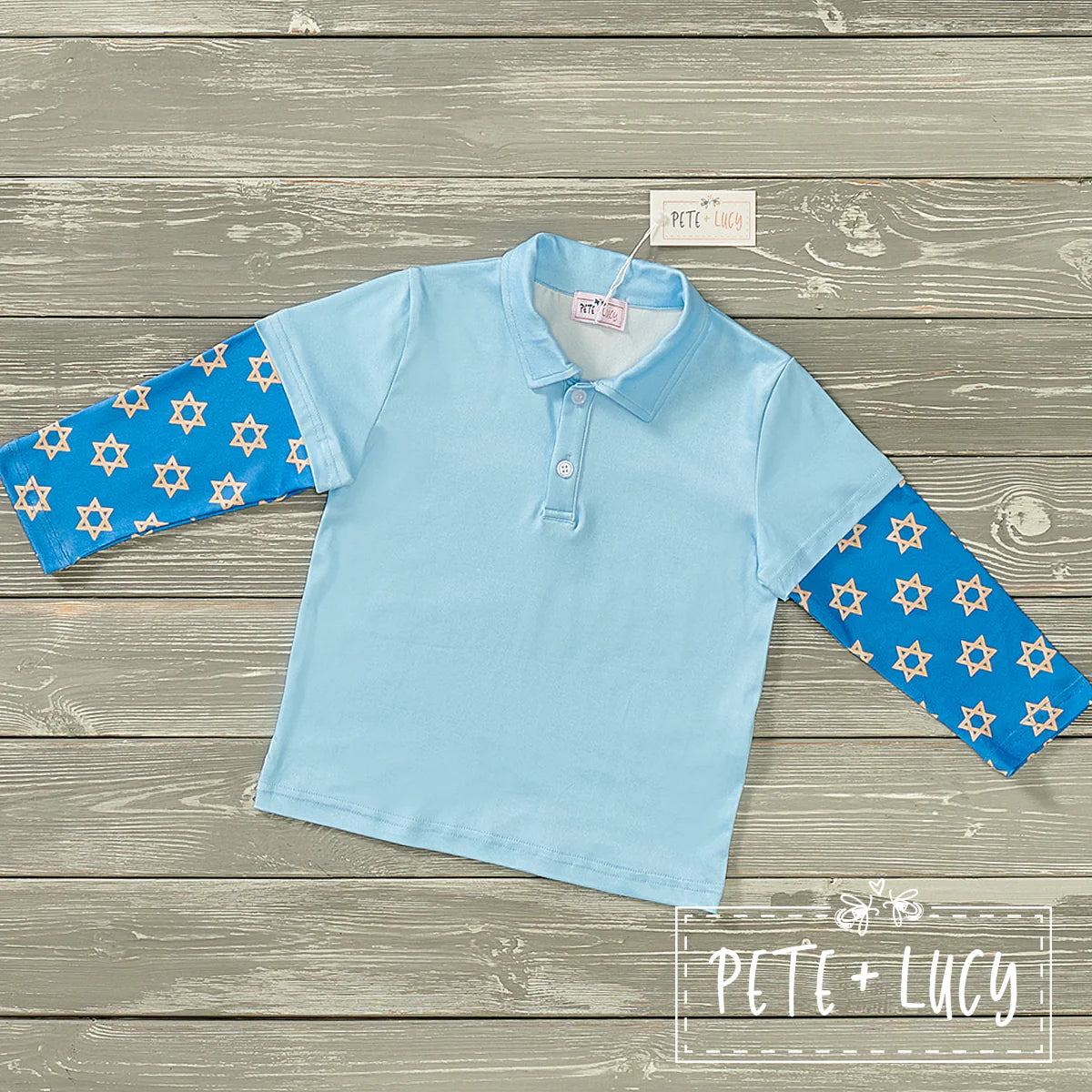 This Dreidle Dreidle Dreidle Boys Shirt is perfect for celebrating the Jewish holidays in style! The light blue collared shirt has a Star of David print on the sleeves, love the mock 2 piece polo shirt design and buttons for the traditional yet trendy look. Time to spin and shout!