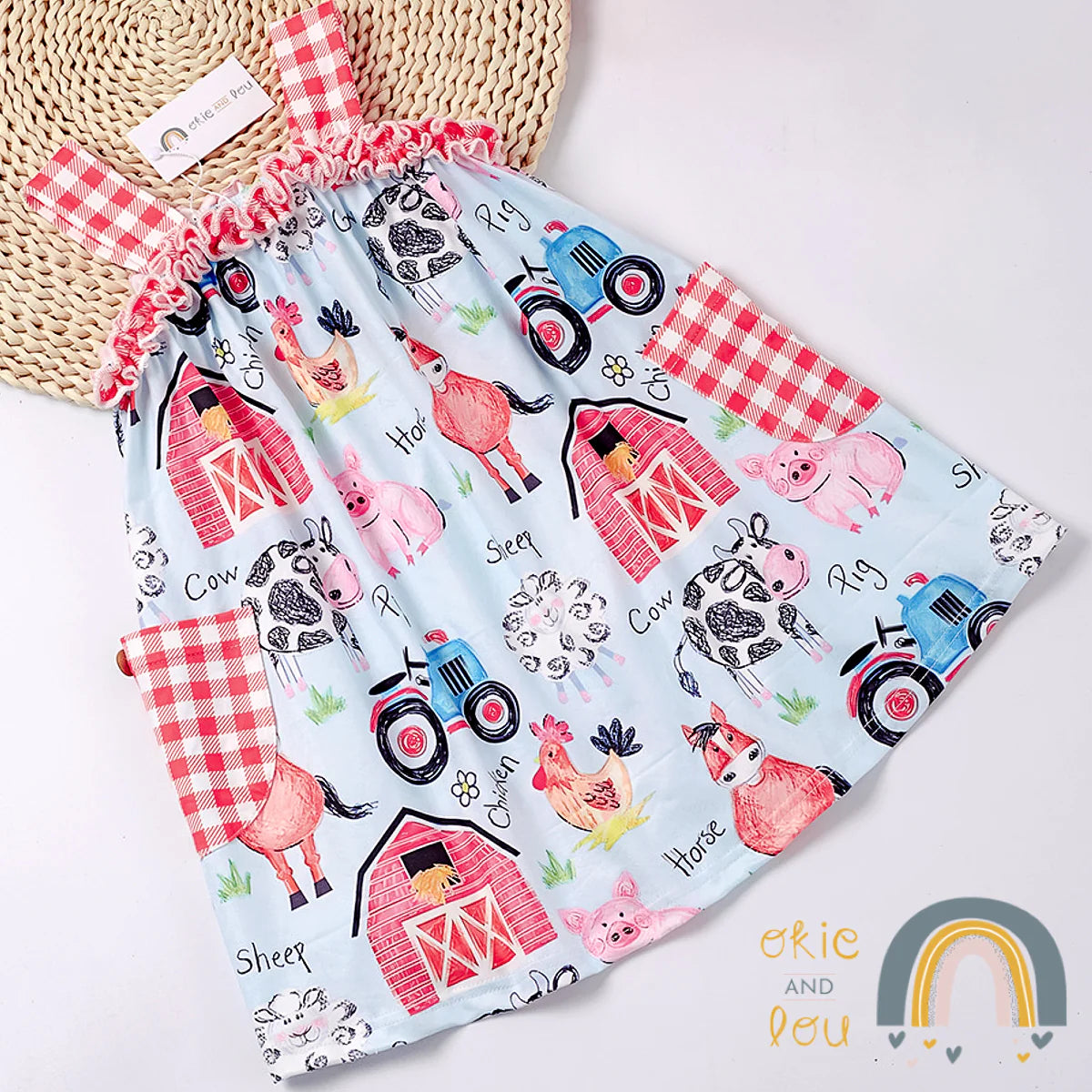 Cute alert! Our Farm Life Sleeveless Dress will have your little one feelin' like a true farmhand. The animals, barn and tractor print fabric is too sweet! The red and white gingham pockets, matching straps and top ruffle are boot-tooting! Check out the other items in the Farm life series for matching sibling sets.