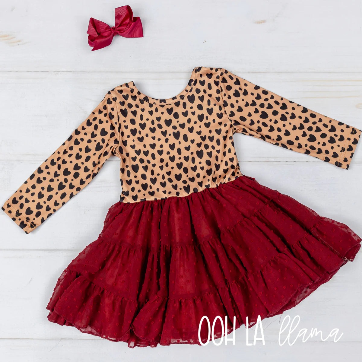 Your little one will be ready to kick up their heels and break hearts in this delightful Heart Beat Twirl dress! With its beautiful heart pattern on the long-sleeved top and deep red layered patterned tulle skirt, this dress has twirling written all over it! Let 'em show off their fluttery style and grace in this oh-so-sweet creation!