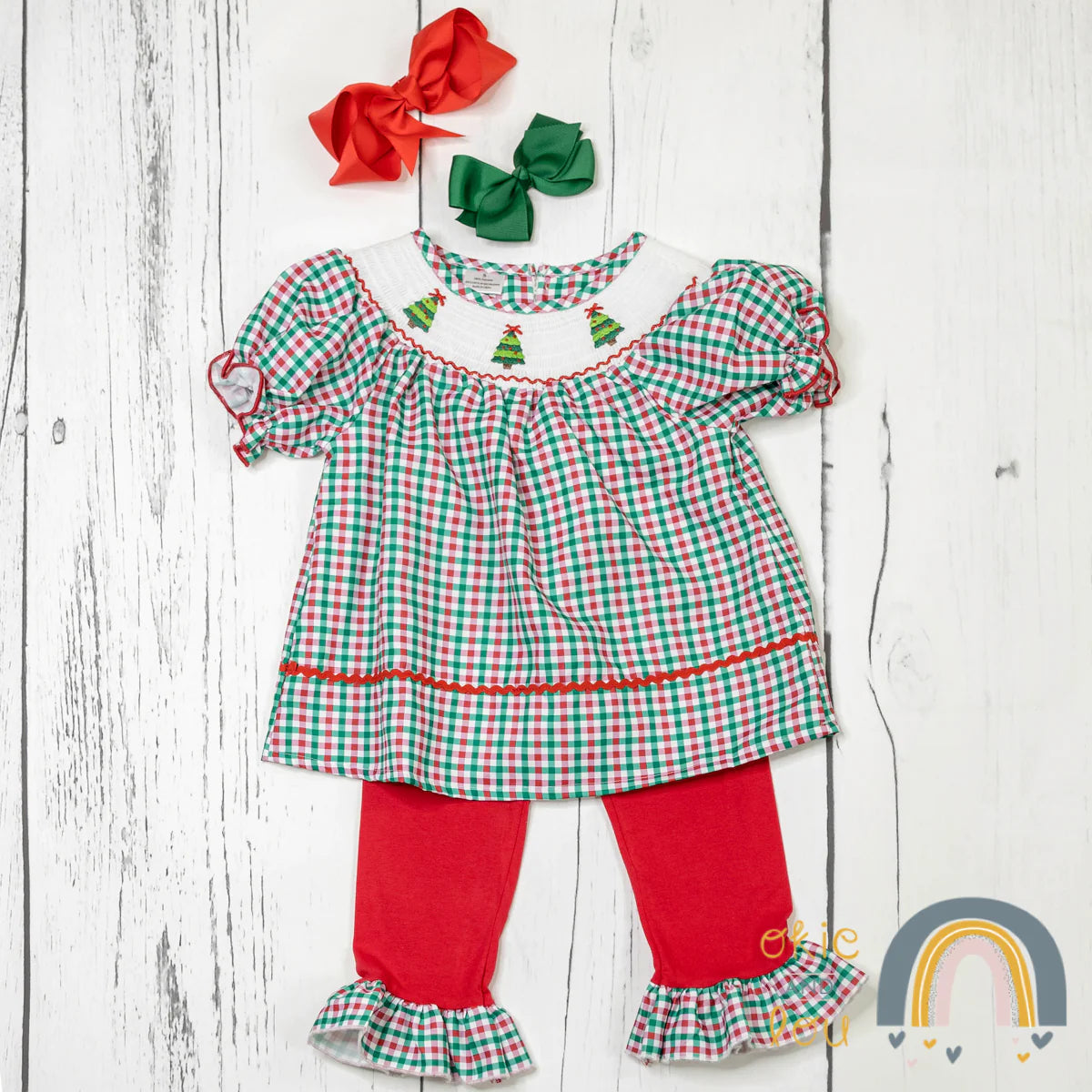 Gingham check and ruffles! Your little girl will look festive and fashionable in this 2-piece Holiday Gingham Pant Set! The sweet smocking on the neckline and adorable ruffle on the sleeve and hem of the pants make it super cute. All that's left is to get ready to rock around the Christmas tree!