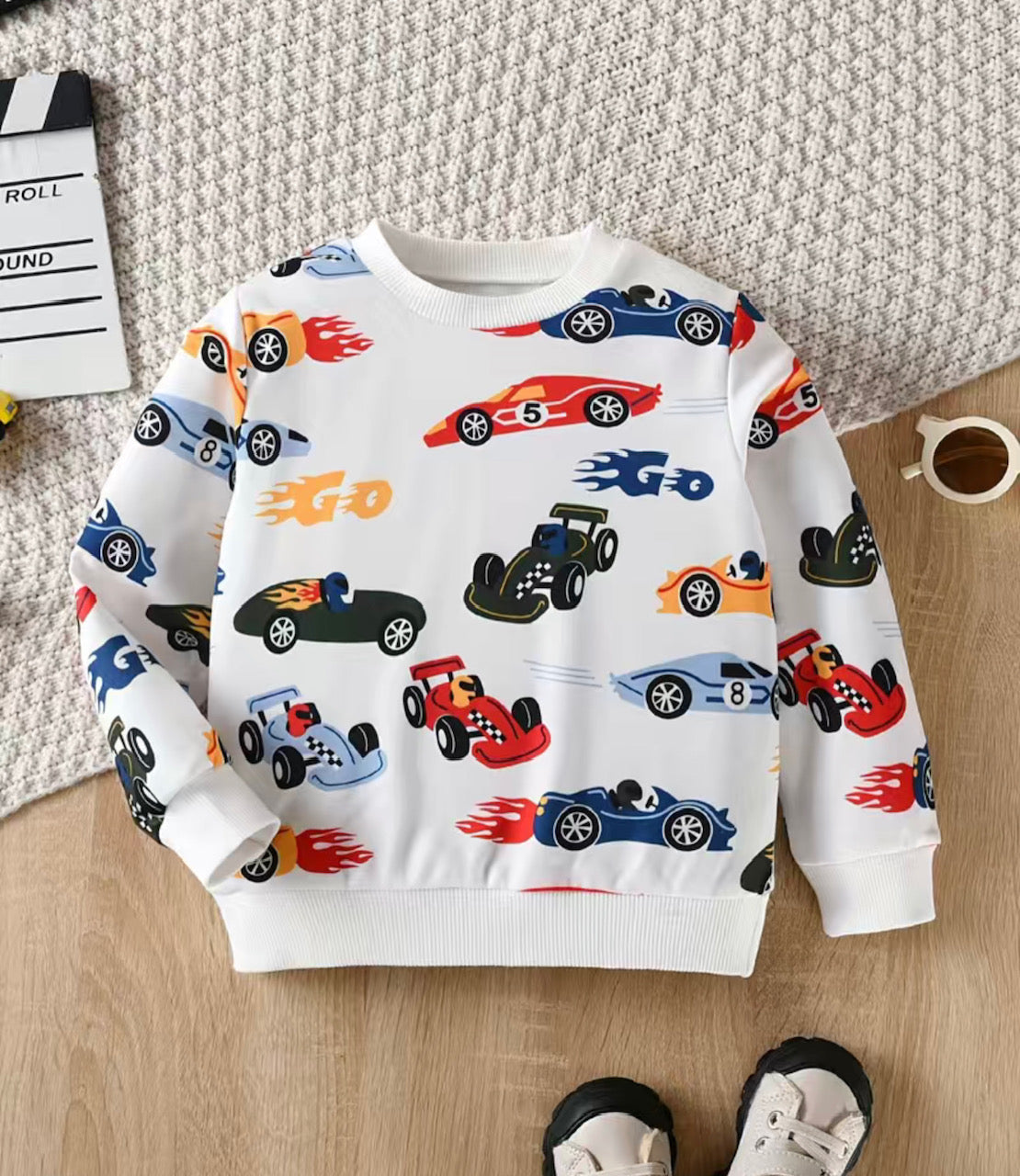 Stay "super speedy" with our Grand Prix Long Sleeve Shirt—featuring a multi car print on a white background. this comfy and stylish top features ribbed cuffs, waist band and collar for unbeatable style and comfort! Ready, set, go!