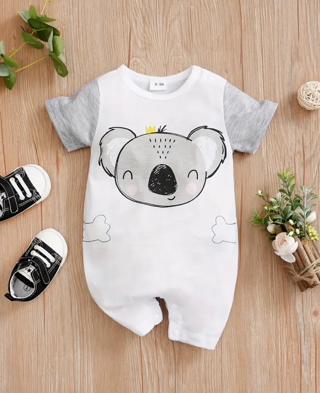 Fall in love with this cozy romper that combines style and comfort with an adorable koala graphic. The snap closure and rounded neck make dressing easy. Perfect for cuddles and playtime, this romper is a must-have for your little one! (No koalas were harmed in the making of this product!)🩶🐨