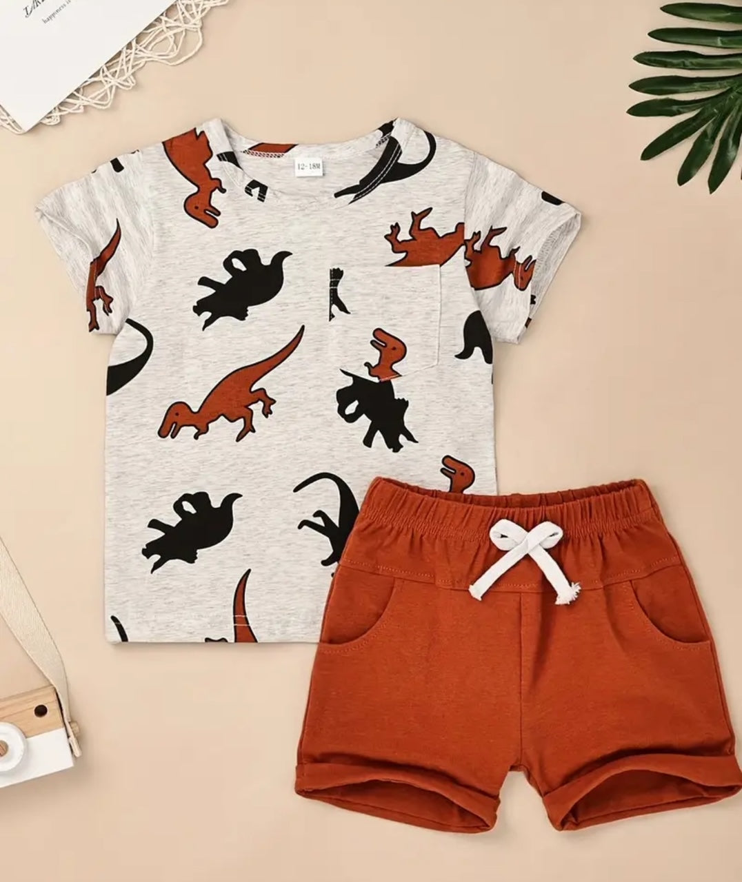 Be a lucky dino in this quirky 2-pc short set! The t-shirt features a rounded neck, short sleeves, and a cheeky chest pocket, while the shorts have an elastic waist with tie, rolled leg, and oh so convenient side pockets. Made with a soft and comfy fabric, it's a must-have for any little explorer.