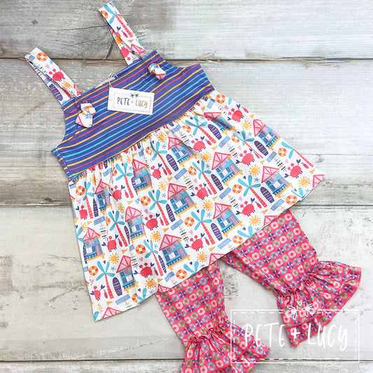 Head into summer in style with this irresistibly adorable and comfy Beach Days 2-piece Capri Set! This cutie features an adjustable strap top, with a great mix of print fabrics, and a flouncy ruffle hem on the pants leg--it's the perfect look for a day of fun in the sun!