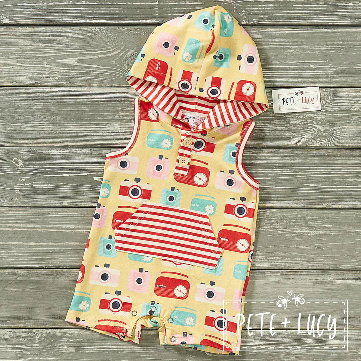 Welcome your lil' dude to summer in style with this Retro boys Shortie-Romper! Not only is it adorable with its hood and kangaroo pocket, but it also features an awesome camera and radio print fabric with contrasting red and white stripes that'll make your kid look fly as heck! Let your kid snap up summer vibes in this classic-meets-cute throwback.