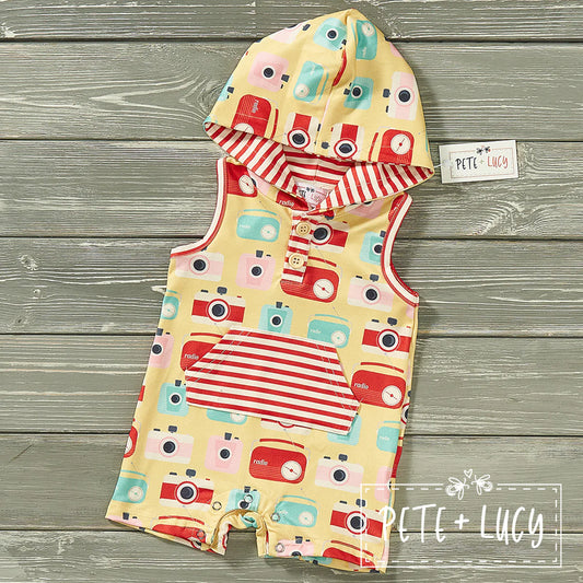 Welcome your lil' dude to summer in style with this Retro boys Shortie-Romper! Not only is it adorable with its hood and kangaroo pocket, but it also features an awesome camera and radio print fabric with contrasting red and white stripes that'll make your kid look fly as heck! Let your kid snap up summer vibes in this classic-meets-cute throwback.