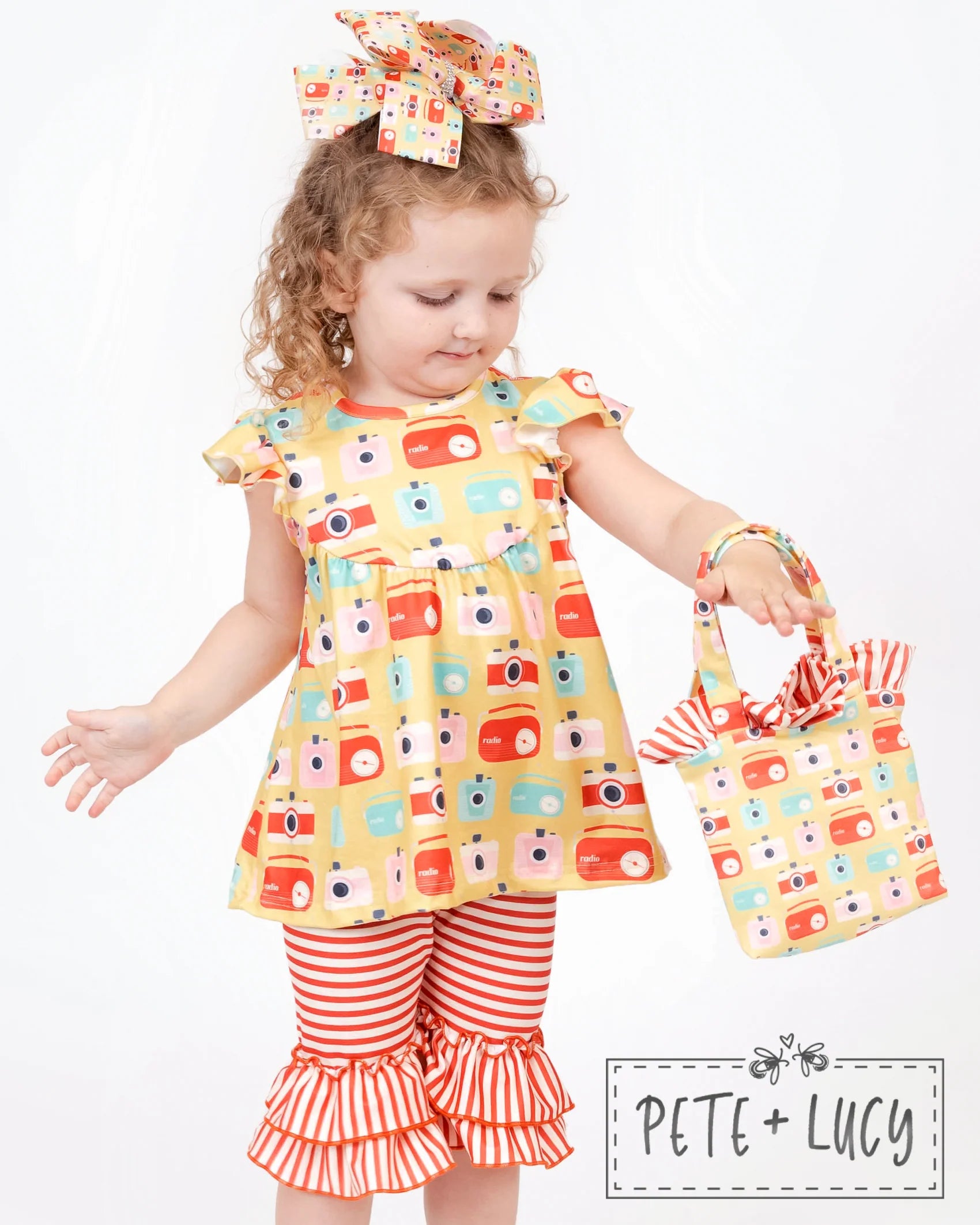 Turn heads this summer with our Retro Summer Capri Set! This adorbs set includes a vintage camera/radio print fabric top with jewel neckline and flutter sleeves, plus red and white stripe capri pants with tiered ruffled hem. This stylish ensemble will have all eyes on you - whether you're chillin' in the park or strolling along the beach! Garty up and hit the town in this fierce 'fit!
