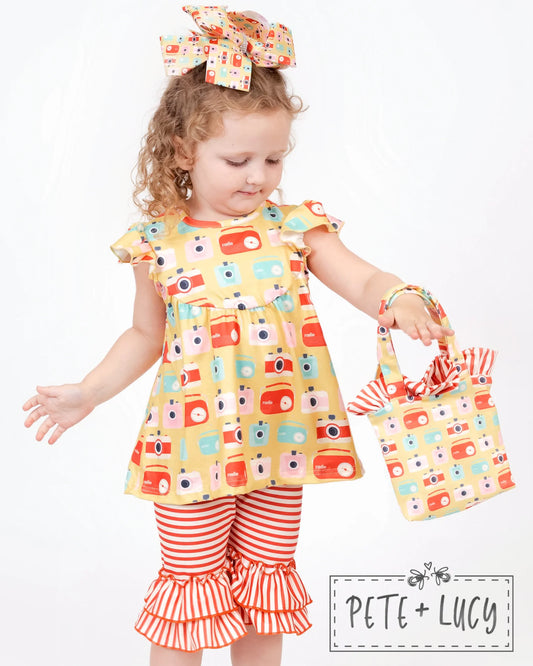Turn heads this summer with our Retro Summer Capri Set! This adorbs set includes a vintage camera/radio print fabric top with jewel neckline and flutter sleeves, plus red and white stripe capri pants with tiered ruffled hem. This stylish ensemble will have all eyes on you - whether you're chillin' in the park or strolling along the beach! Garty up and hit the town in this fierce 'fit!