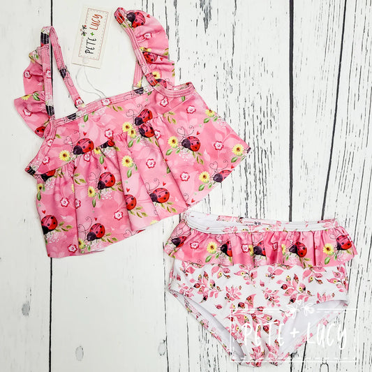 Get ready for some fun in the sun with our Sweet Ladybugs swimsuit! This 2-piece set features an adorable flutter sleeve and loose ruffle top, perfect for splashing around. And did we mention the cute ladybug print? This swimsuit is a must-have for any beach day👙