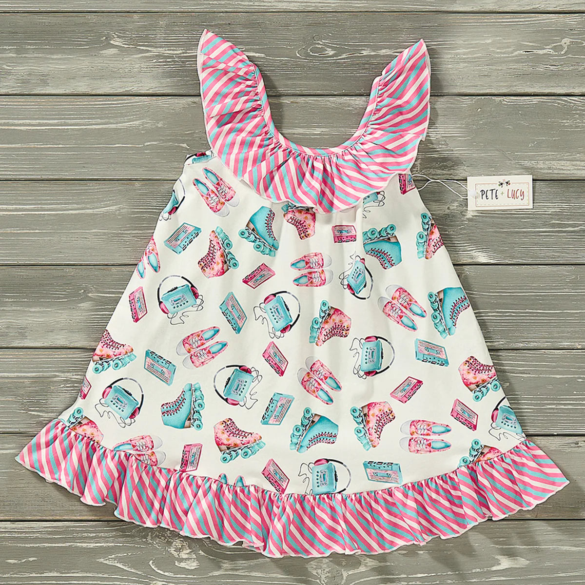 For the ultimate summer look, the Skater Girl Dress is the perfect choice. This dress features a delightful roller skate and stripe fabric pattern in bright pinks and turquoise. The halter neckline, ruffle accents, and trapeze cut add a flirty flair, while the ruffle hem adds a fun and flouncy touch.
