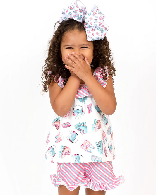 This Skater Girl 2 Piece Short Set is perfect for your active girl! Made from a comfortable fabric blend, this outfit features a halter neckline, ruffle accents, a tunic style top and shorts with a garterized waist, and a ruffle hem. The fun roller skate and striped print fabrics in pinks and turquoise lend a fun and stylish touch to this look.
