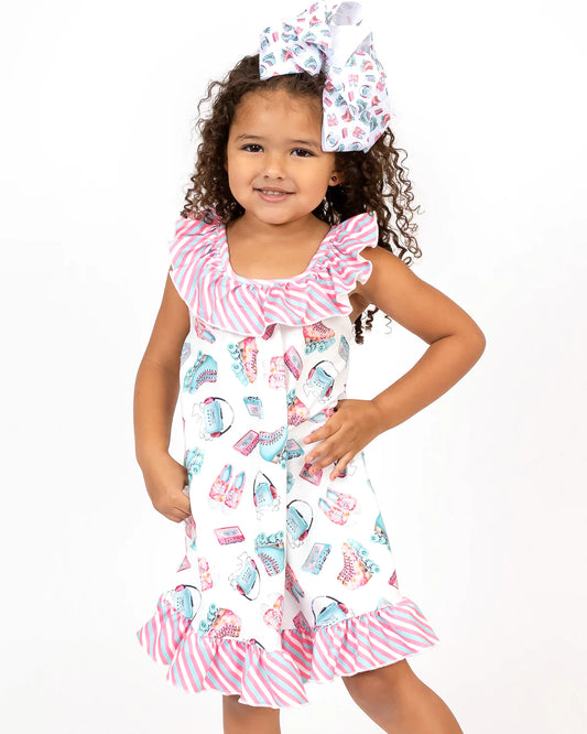 For the ultimate summer look, the Skater Girl Dress is the perfect choice. This dress features a delightful roller skate and stripe fabric pattern in bright pinks and turquoise. The halter neckline, ruffle accents, and trapeze cut add a flirty flair, while the ruffle hem adds a fun and flouncy touch.