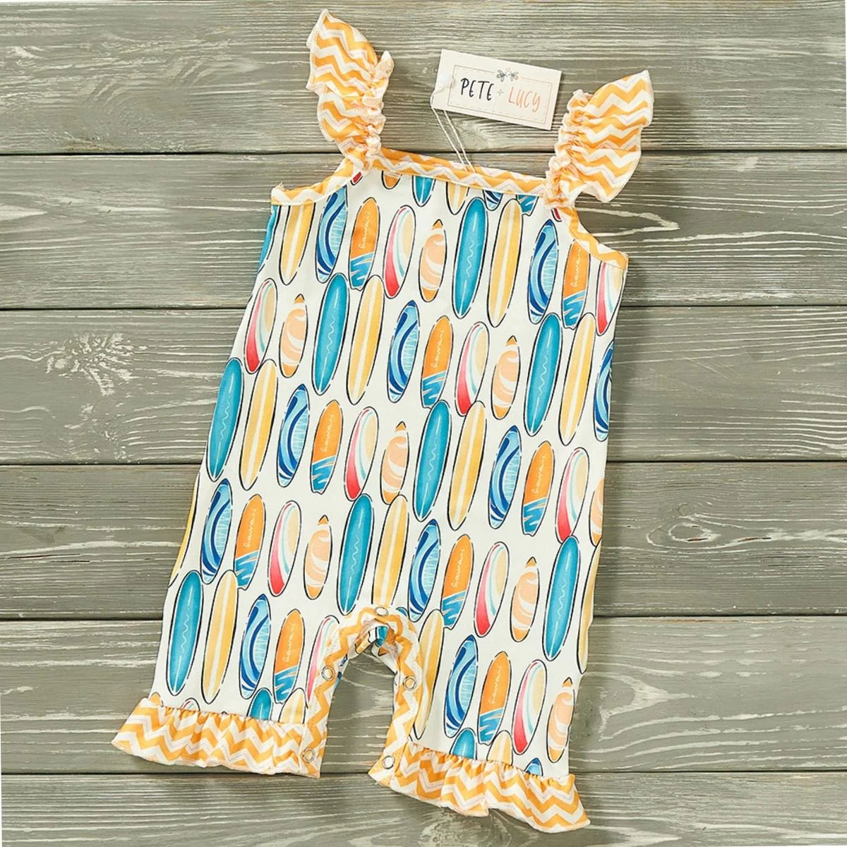 Looking for a fun and quirky romper for your little girl? Look no further than our Sun and Surf Girl's romper! Featuring a square neckline, flutter sleeves, and a snap up closure, this one piece romper also has a charming ruffle hem. And let's not forget the adorable surf board and zigzag prints that will make your little one stand out at the beach or playground!