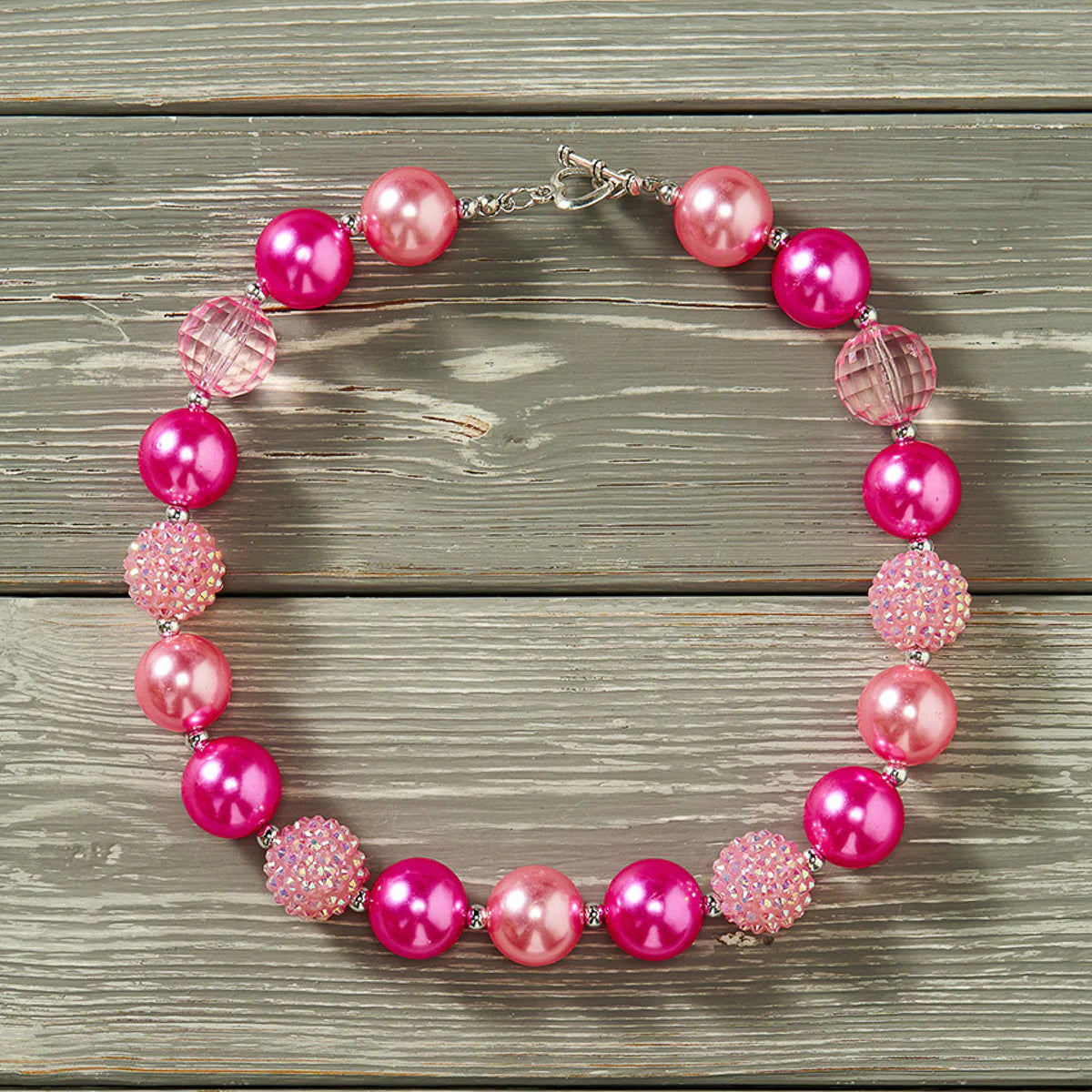 Complete the look with one of our Bubble Gum Necklaces — a chunky 18" of fun your kid won't be able to resist! With a clasp for easy closure and beads that look good enough to eat (but don't!), it's the perfect accessory for any kiddo!