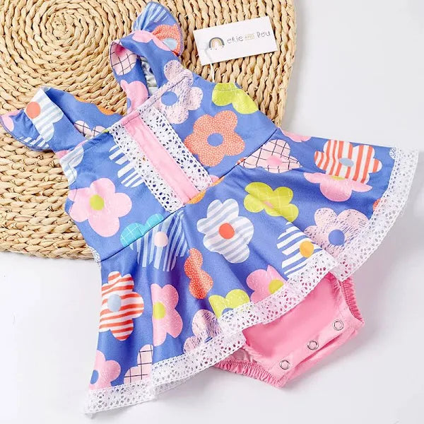 Get ready to bloom with our Colorful Flowers Girl's Infant Romper! Featuring a large, eye-catching multi-color floral print, lace trim, and flounce style skirt and flutter sleeves, this romper is perfect for your little fashionista. (Bonus points for the adorable photo op!)