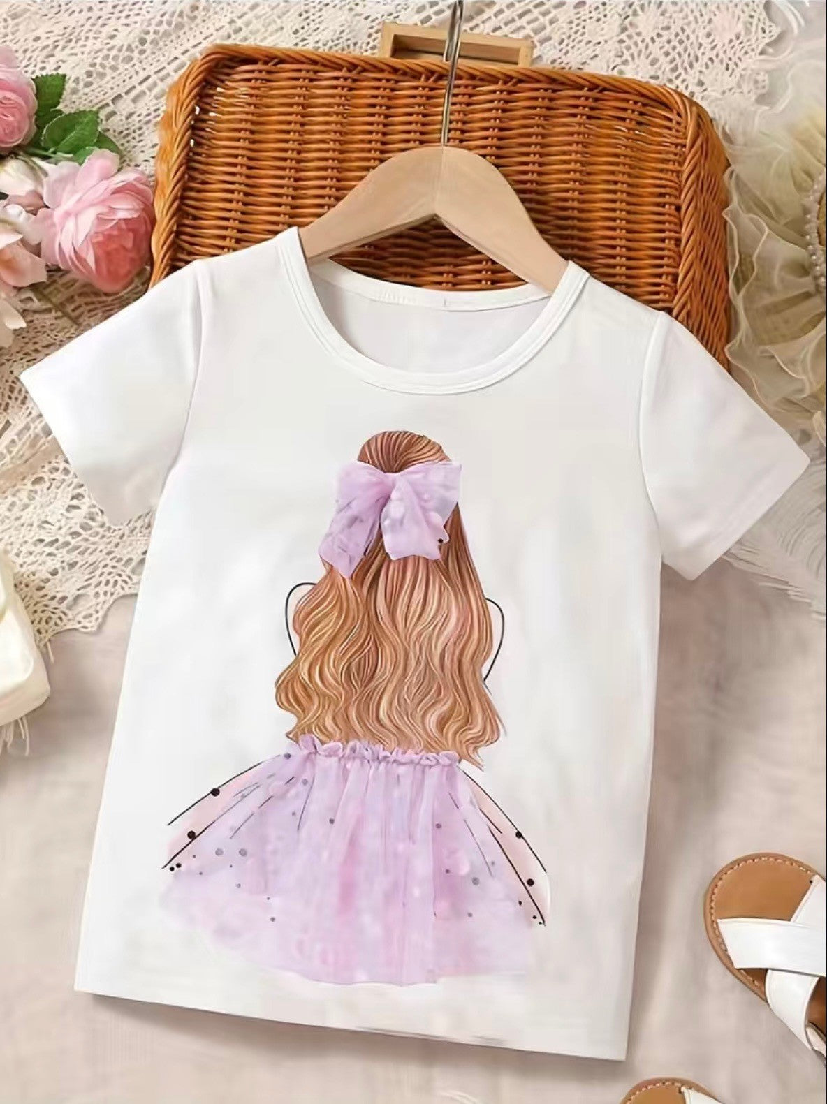 This girl's t-shirt is so adorbs she'll be the envy of all the other kids! It features a 3-D tutu and matching hair bow in both pink and light purple, giving a look that really pops! Perfect for any party or just for playing around, she won't want to take it off!