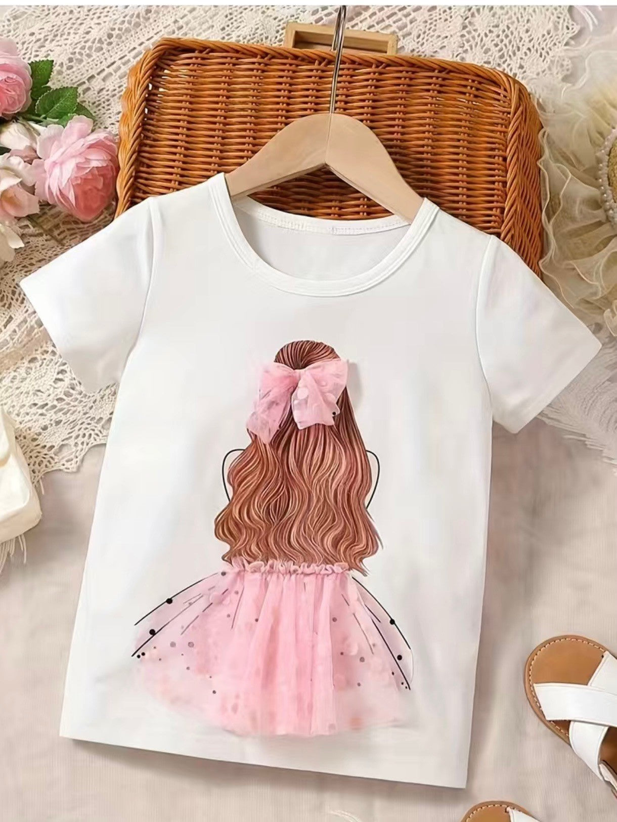 This girl's t-shirt is so adorbs she'll be the envy of all the other kids! It features a 3-D tutu and matching hair bow in both pink and light purple, giving a look that really pops! Perfect for any party or just for playing around, she won't want to take it off!