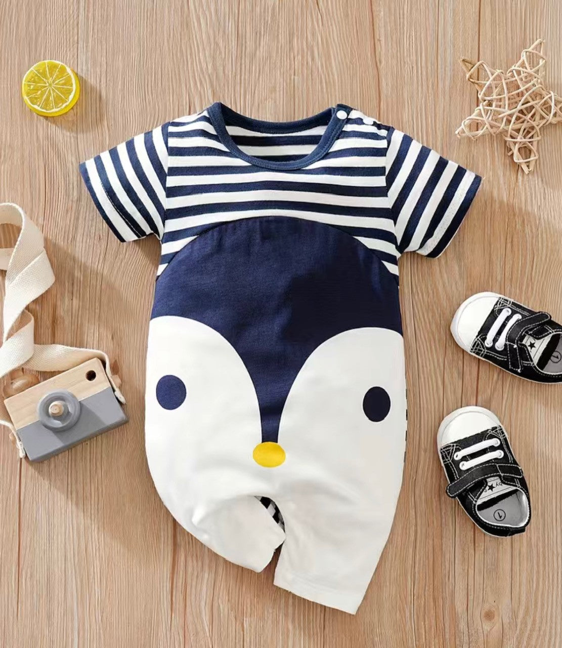 What's cute, cuddly and oh-so-stylish? The Penguin Love Shortie Romper! Its playful navy and white colors and round neck style make it perfect for your little one's early transitions (rolling, crawling, walking). Plus, the snap closure at the neck and crotch make it easy to change the baby. This romper is sure to be a hit - it's super cute and inspired by nature's most lovable creatures!