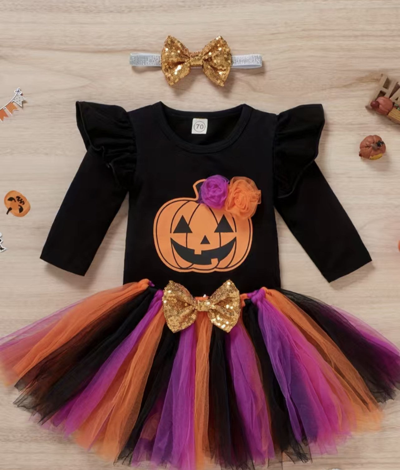 This Pumpkin Tulle outfit will have your sweetie looking cuter than any jack-o-lantern! The cozy onesie with pumpkin and tulle accents, and flutter shoulder sleeves will keep her warm and comfy. Meanwhile, the twirly tulle skirt with its bold black, orange, and fuchsia hues is finished off with a shimmering gold sequin bow that perfectly matches the headband - so sweet! Spruce up any fall look with this charming 3 piece set!