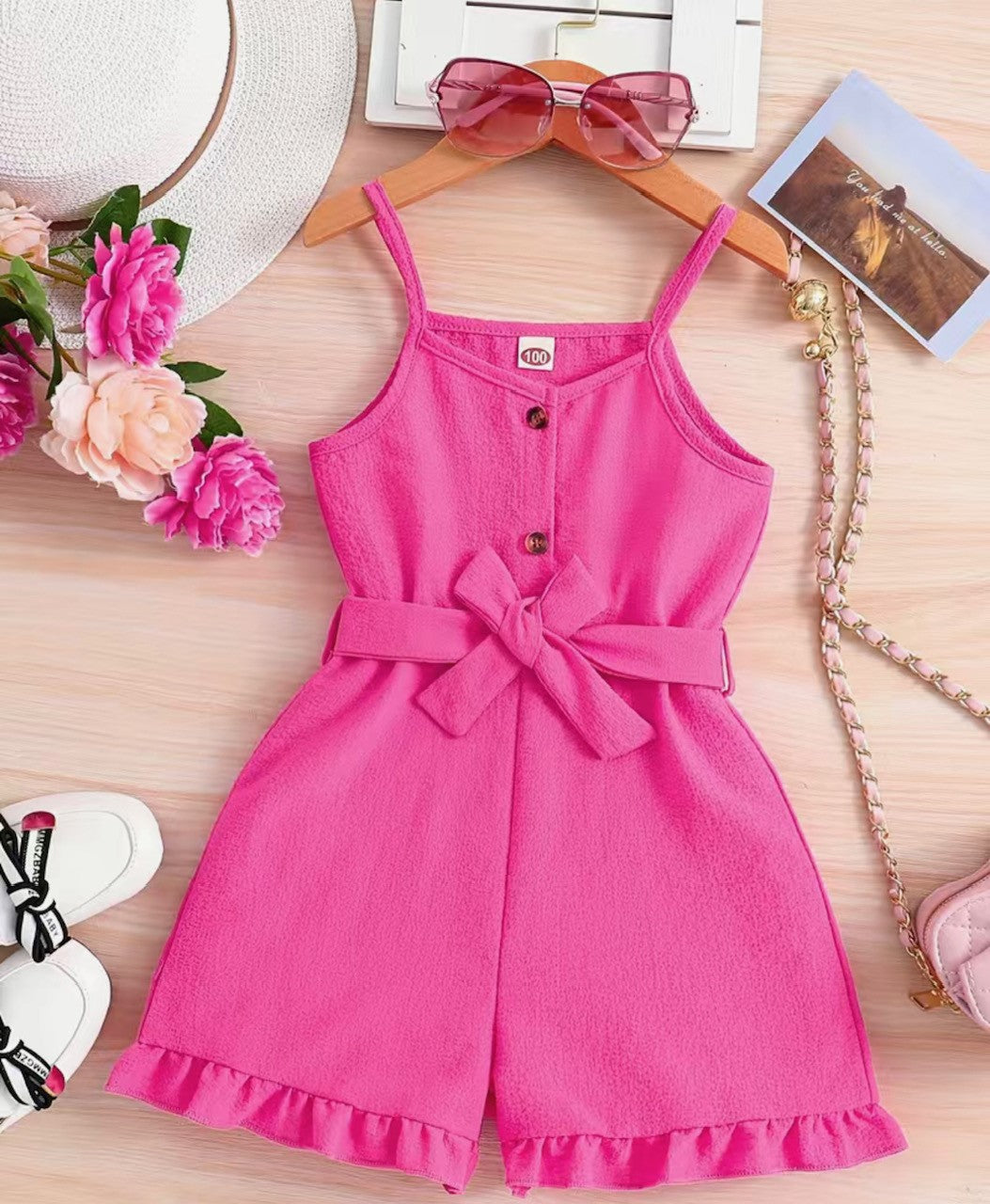 This Pretty in Pink Sleeveless Jumper is the perfect way to show your girly style in the summer! With its spaghetti straps, belted high waist and ruffle hem, you'll be the "belle of the ball" in Barbie Pink! Let 'em know you mean business in this shorts jumper.