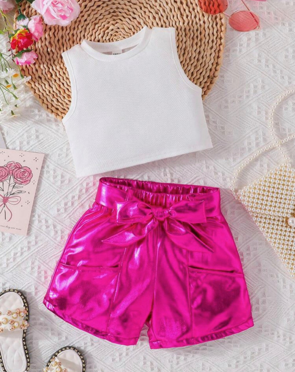 Unlock your inner Barbie in this awe-inspiring 2-piece set. Show off your style with the white tank crop top and sparkling hot pink metallic shorts, complete with two conveniently placed pockets and a matching belt. Whether you’re looking to make a statement or just add to your wardrobe, this short set is a must-have!