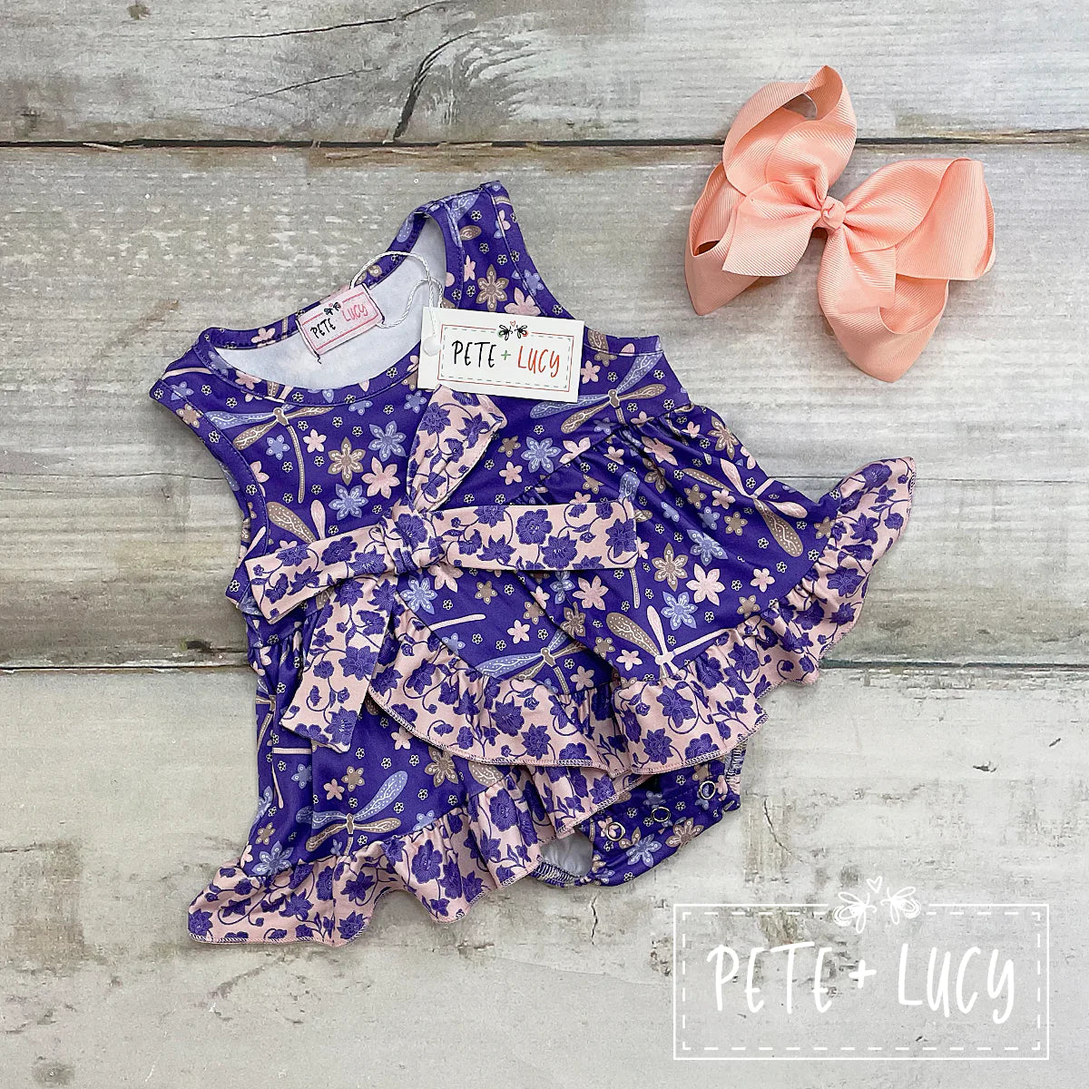This adorable sleeveless romper is perfect for any occasion. We love the use of the dragonfly and floral print, and the sweet layered ruffle. Check out the sibling outfits in the matching fabric.