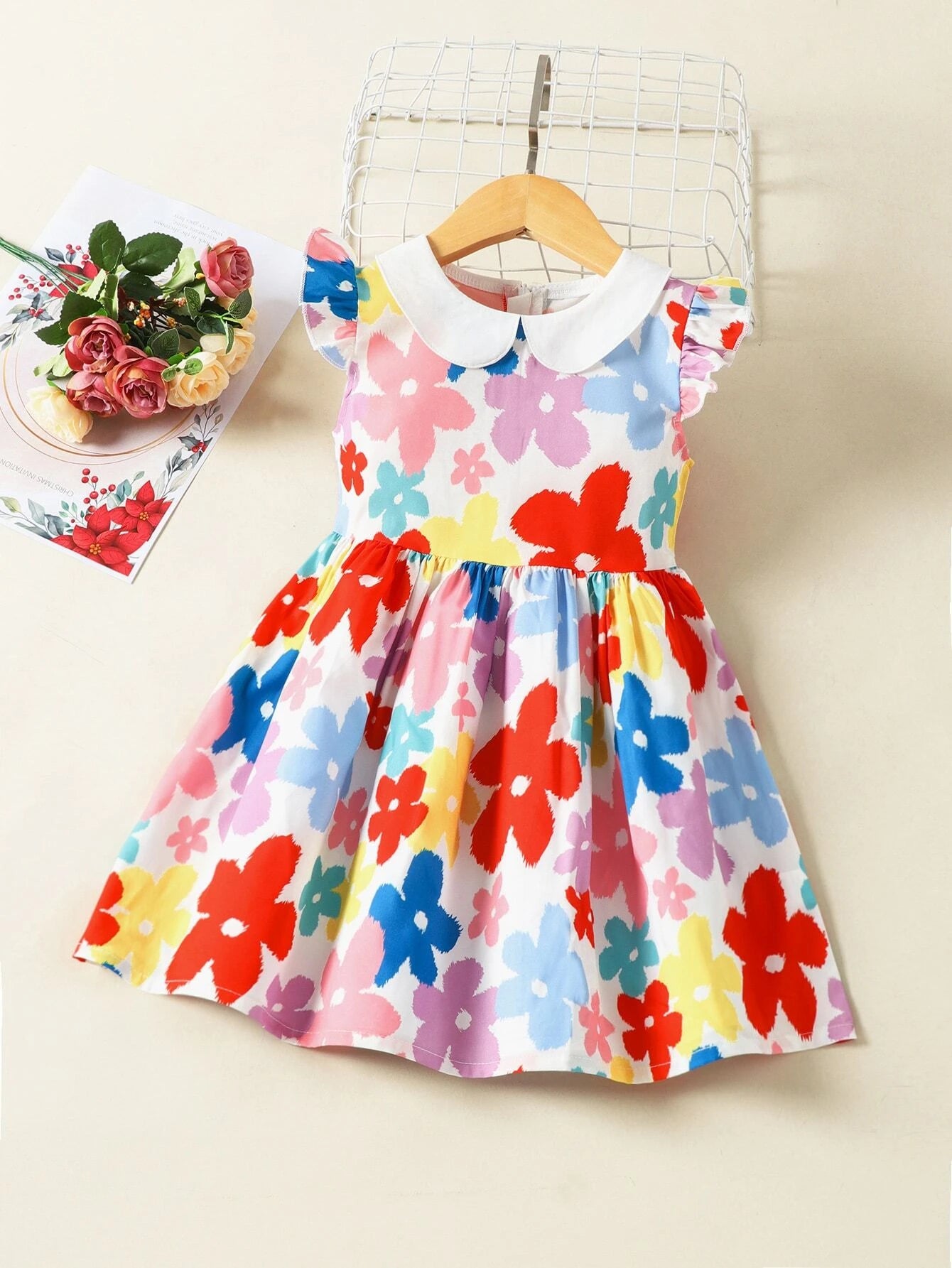This adorable large floral print a-line dress is a must for your little beauties wardrobe this spring/summer. We love the use of color in the floral print as well as the peter pan collar and butterfly style capped sleeve. 