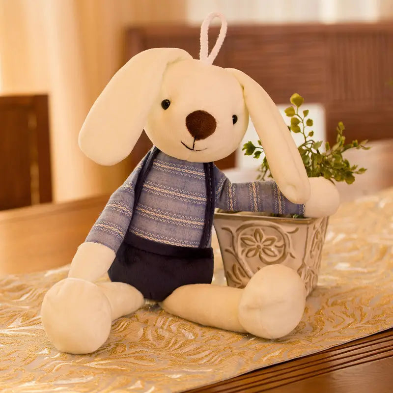 This adorable floppy eared bunny stands 15.7 inches tall. The bunny is adorned with Navy blue overalls and a blue and white stripe top. The perfect friend for your little guy or gal!