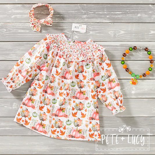 This darling long sleeve Pumpkin print dress is a Fall must-have for your little ones! The smocked detailing is simply stunning - perfect for a fabulous fall pic! Your kiddo will be the talk of the town in this chic pumpkin print dress - and they'll stay fashionable and comfy all season long! Smocking is the perfect way to add a bit of fun to a timeless print.