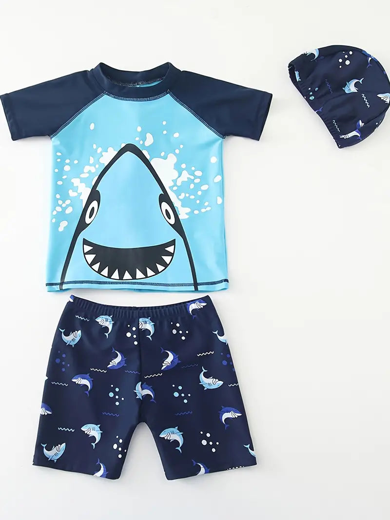 Make a splash in style with the Shark Bite 3-piece Boy's rashguard Swimsuit! The adorable shark design and back fin will have him swimming circles around the other kids at the beach, while the UPF 50 rashguard will keep him sun-safe. Plus, the matching swim hat is the perfect way to complete the look! ˆÜˆ sharks included.