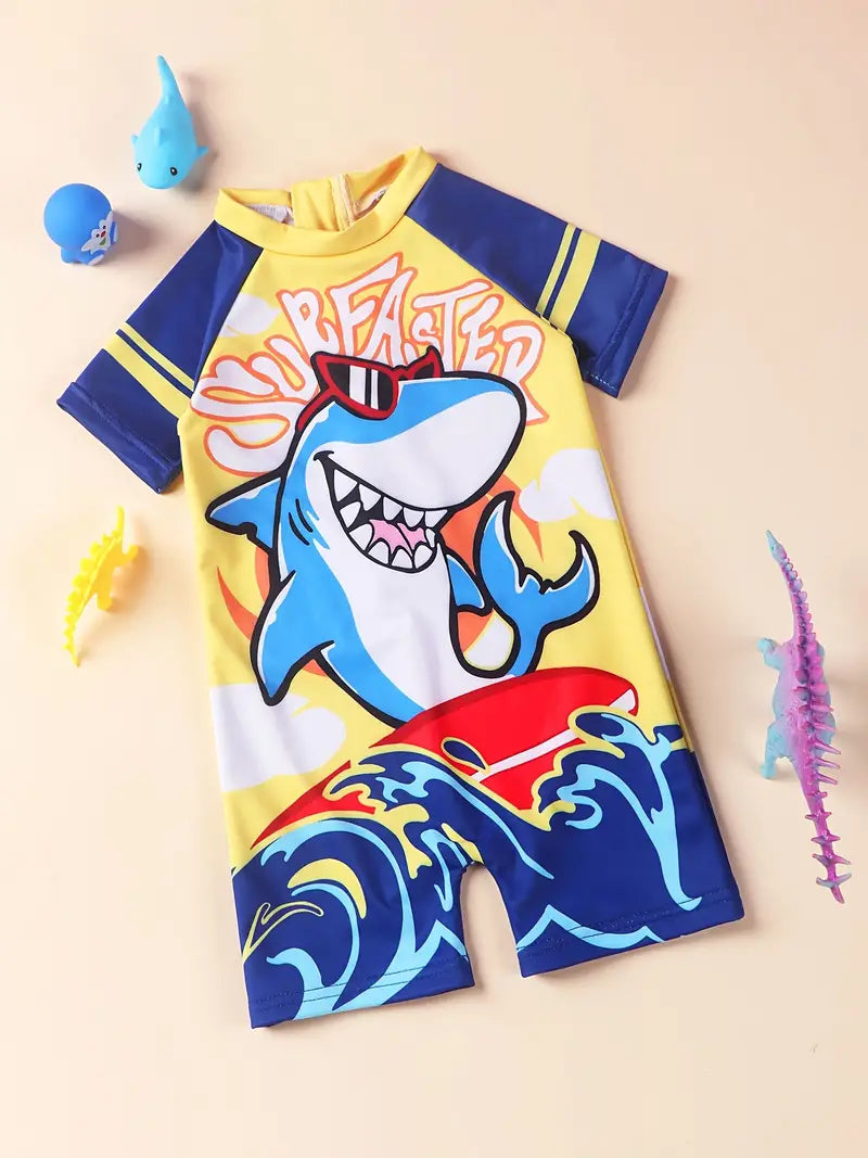 Make a splash with this “fintastic” Surfaster Shark Shortie Boys Swimsuit! The super cute design features a surfing shark and the UPF 50 fabric will keep your little man sun-safe! Enough said! 🦈