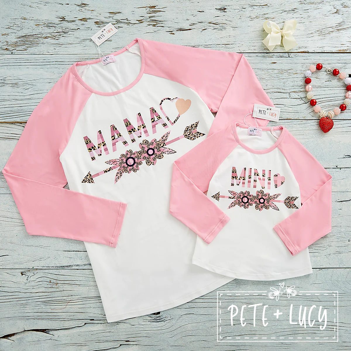 How adorable will you and your little ones look in these matching pink and white long sleeve raglan t-shirts! We love the soft "milksilk" fabric, the finished edge on the rounded neckline and of course the adorable MAMA and MINI graphic with the hearts and arrows on the front of the tee. This is the Mini Version, look for the Mama