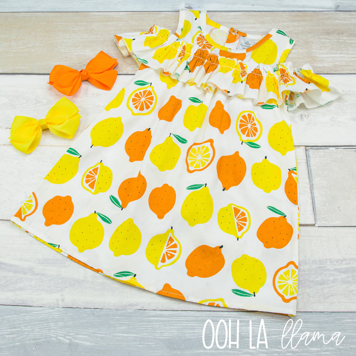 How cute is this A-Line, cold shoulder top ruffle dress. The citrus print is so refreshing, your little one can definitely squeeze the day in this beauty!