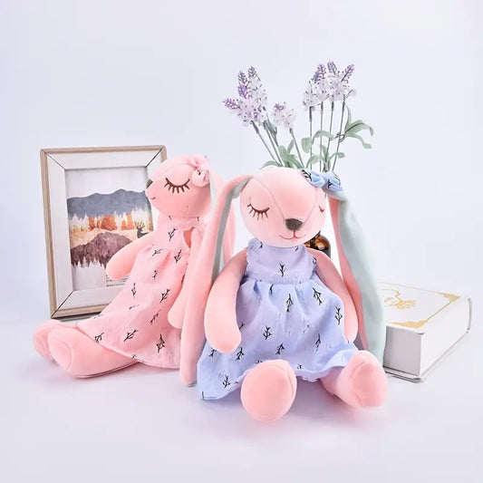 This adorable floppy eared bunny stands 13.7 inches tall. The bunny is adorned with a cute dress and matching bow on the ear. The perfect friend for your little guy or gal! Comes in both a pink or blue dress.