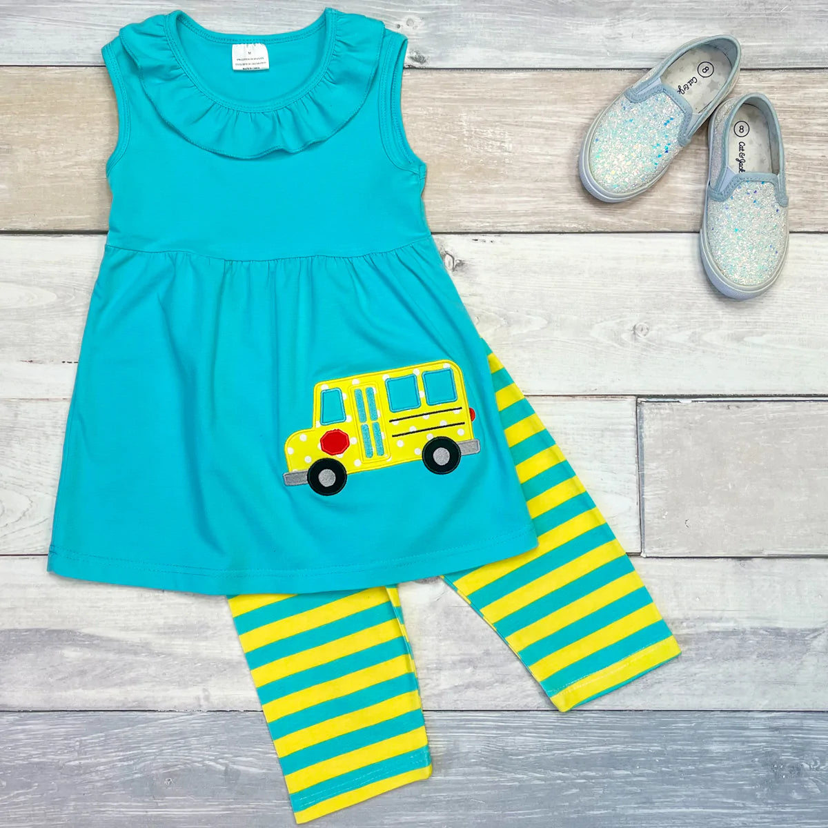 Back to school has never looked better. This adorable 2 piece striped pant, ruffled neck sleeveless look is perfect for the season. Pair it with a super cute hair bow or a great book for an awesome gift!