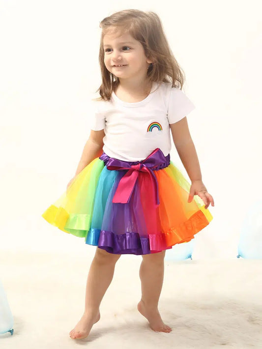 These beautiful multi-color tulle skirts are precious! We love how the ribbon on the hem matches each color section. The waistband is elastic and ties with a dual color  bow. This can be paired with a shirt as shown in the photos for everyday wear, or used for dress-up for your little one with a fantastic imagination!