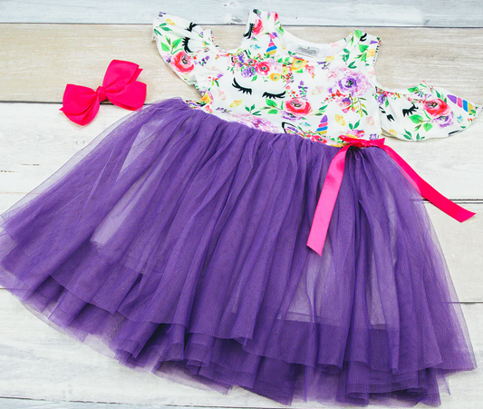 Calling all unicorn lovers! The whimsical print on this cold shoulder dress is precious, especially when they paired it with the layered tulle and the pink satin bow.This is a must for your little dreamer!