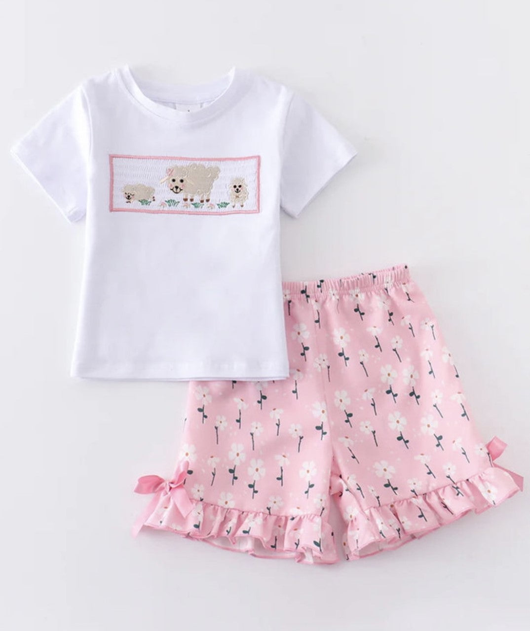 This 2-piece pink floral and lamb set is perfect for the little fashionista in the making! With a fun floral print short and sweet smocking shirt with a lamb design she'll look oh-so-cute and comfortable in this outfit. Ruffled trim adds an extra touch of cuteness! Get ready to gush!